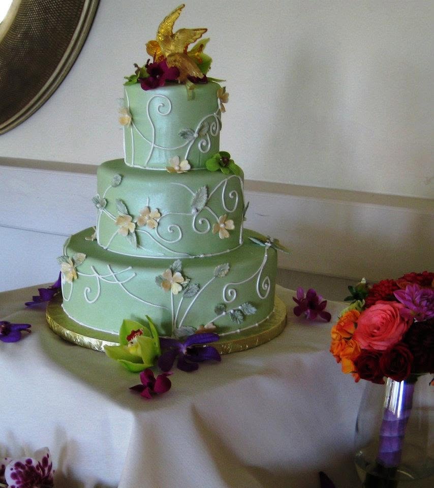 Sage green tiered cake with gold butterfly